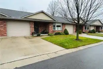 Ranch-style house with a front lawn and a garage