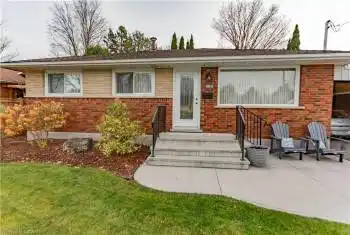 Ranch-style house with a front lawn and a patio