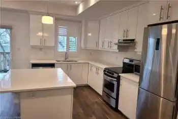 Kitchen featuring sink, a center island, hanging light fixtures, and appliances with stainless steel finishes