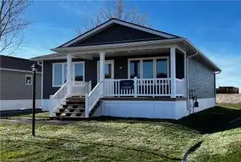 View of front of home with a porch and a front yard