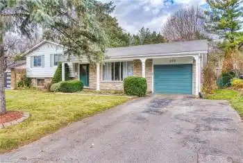 Tri-level home with a garage and a front lawn
