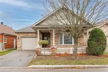 View of front of home with a porch and a garage