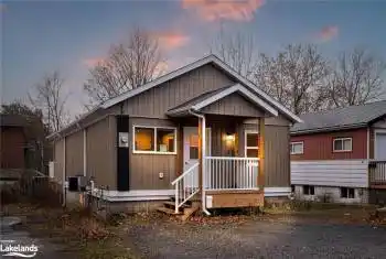 View of front facade with central air condition unit and a porch