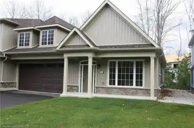 View of front of property featuring a garage and a front yard